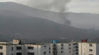 Дым над военной базой в Каракасе. Фото АР
